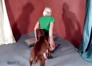 Blonde in green is about to fuck a dog