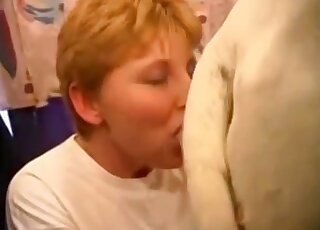 Short-haired lady blows a white animal