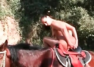 Slender chick poses naked on her stallion