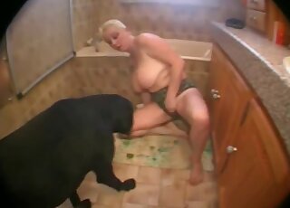 Busty blonde is enjoying her trained black dog